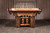 Doc & Holliday Woodslee Slate Pool Table, rustic wooden pool table with a natural wood finish and leather pockets, set in a wooden barn-like room.