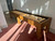 Brunswick Billiards Brunswick Parsons Pool Table & Shuffleboard Combo, a wooden game table with a shuffleboard surface and pool cues, in a well-lit room.