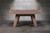 Doc & Holliday George Slate Pool Table by Doc & Holliday, Grey Walnut, showing a modern design with a slate playing surface and wooden legs against a textured gray wall.