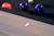 Doc & Holliday George Slate Pool Table by Doc & Holliday with Glazed Pearl finish, featuring a close-up of the pool table surface with billiard balls in the background.