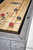 Brunswick Billiards Brunswick Sanibel Pool Table & Shuffleboard Table, close-up of the shuffleboard surface with pucks and scoring lines.