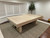 American Heritage Billiards Vancouver 8' Slate Pool Table in Natural Ash, wooden pool table with a light natural wood finish in a room with white walls, shutters, and a beige carpet.