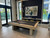 American Heritage Billiards Vancouver 8' Slate Pool Table in Natural Ash by American Heritage, modern game room with pool table, pool cues, and contemporary decor.