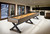 Brunswick Billiards Brunswick Premier Shuffleboard Table, modern indoor game room with large windows, black and wood finishes, and sleek decor.