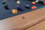 Doc & Holliday Preakness Pool Table in Maple, close-up view of the wooden corner and billiard balls on the felt surface.
