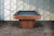 Doc & Holliday Preakness Pool Table in Gray Walnut, modern billiards table with sleek wooden finish and black playing surface in front of a decorative wall.