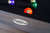 Doc & Holliday The Metalsmith Pool Table by Doc & Holliday, showing a close-up of the table's surface with a brand logo and colorful billiard balls.