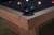 Doc & Holliday Kaci Slate Pool Table in Grey Walnut, close-up of the corner showing the black bumper and pool balls on the black felt surface.