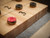 Doc & Holliday George Shuffleboard Table, gray walnut with numbered sections and round pucks on the playing surface.