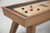 Doc & Holliday George Shuffleboard Table in Gray Walnut, close-up view showing the wooden surface and playing tokens.