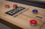 Doc & Holliday logo on maple shuffleboard playfield with red and blue pucks and scoring detail