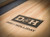 Detailed view of the Doc & Holliday logo on the smooth maple butcher block playfield, showcasing premium USA craftsmanship.