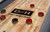 Doc & Holliday Hank Shuffleboard in Rustic Silver Brown Oak Finish, close-up of the tabletop with shuffleboard pucks on it.