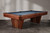 Doc & Holliday Preakness Slate Pool Table in Walnut & Maple, showcasing a stylish wooden pool table with a slate playing surface, sleek wooden legs, and a modern design.