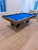 Plank & Hide Co Essex Steel Slate Pool Table, modern pool table with a sleek metallic frame and bright blue felt surface in a spacious living room.