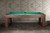 Doc & Holliday Paula Parsons Pool Table in Antique Coffee, rectangular wooden pool table with green felt surface against a textured wall.