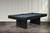 Doc & Holliday The Jackies Slate Pool Table in Black, modern pool table with a sleek black finish and blue felt surface, placed in a stylish room with decorative wall paneling and concrete flooring.