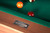 Doc & Holliday Paula Parsons Pool Table in Gray Walnut, close-up of the table's nameplate and green felt surface with pool balls.