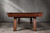 Doc & Holliday Muse Slate Pool Table by Doc & Holliday, a sleek wooden pool table with a polished finish placed against a wooden wall.
