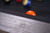 American Heritage Billiards Alta Pool Table in Marble Grey, close-up view of the textured marble grey surface with billiard balls in the background.