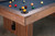American Heritage Billiards Vancouver Slate Pool Table in Honey Ash, close-up of the corner showing a slate playing surface with billiard balls and wooden frame.