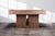 American Heritage Billiards Vancouver Slate Pool Table in Honey Ash, modern wooden pool table with slate surface and honey ash finish, placed on rustic concrete floor with natural light.