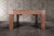 American Heritage Billiards Alta Slate Pool Table in Honey Ash, modern designed pool table with a wood finish, placed on a concrete floor with a tiled wall background.