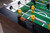 Doc & Holliday Parsons Foosball Table | Doc & Holliday x Tornado, showing the close-up of the foosball table with yellow players and wooden soccer ball.