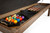 Brunswick Billiards Brunswick Centennial Storage Bench, open storage bench with billiards accessories including pool balls, cues, and brushes inside.