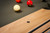 Close-up of the custom black hammered billiard sights embedded in the natural wood rail of the Brunswick Hickory 8' Slate Pool Table, showcasing the table’s high-end design and intricate detailing. Close-up of the custom black hammered billiard sights embedded in the natural wood rail of the Brunswick Hickory 8' Slate Pool Table, showcasing the table’s high-end design and intricate detailing.