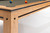 Brunswick Billiards Brunswick Hickory 8' Slate Pool Table - Natural Hickory Finish, close-up view of the corner showing the wooden frame, black accents, and felt surface with billiard balls.