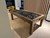 Brunswick Billiards Brunswick Parsons Air Hockey Table, wooden frame with black playing surface and white markings, located in a modern indoor game room.