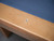 Doc & Holliday Kaci Slate Pool Table – Glazed Maple, close-up of the corner showing a wooden finish and a blue felt playing surface.
