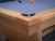 Doc & Holliday Kaci Slate Pool Table – Glazed Maple, close-up of the table corner showing the smooth wooden finish and black corner bumper.