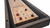 Plank & Hide Co Hamilton Pool Table & Shuffleboard Combo, showcasing a wooden shuffleboard with puck markings and pucks, with a black and wood finish frame, designed for versatile game entertainment.