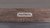 Plank & Hide Co Lucas Pool Table & Shuffleboard Combo, close-up of the metal logo plate on the wooden playing surface.