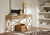 Hooker Furniture Retreat Pole Rattan Dune Console, wooden console table with natural finish, placed in a modern interior setting with decorative items on top.