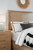 Hooker Furniture Retreat California King Cane Panel Bed, elegant bedroom setup with neutral tones, upholstered headboard, and coordinated bedding accessories.