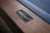 Close-up view of the steel nameplate on the Doc & Holliday Hank pool table in distressed Rustic Silver Brown Oak