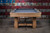 Front view of the Doc & Holliday Hank pool table in Rustic Silver Brown Oak with Championship felt, shown in a rustic contemporary setting