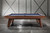 Doc & Holliday Nash Pool Table by Doc & Holliday, USA Made, modern style billiards table with a blue felt playing surface and wooden finish, set against a minimalist industrial interior with a white brick wall.