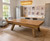 Doc & Holliday George Slate Pool Table by Doc & Holliday in Glazed Maple, modern dining room with natural light, framed family photos on the wall, and cozy seating area.