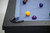 Plank & Hide Co Beaumont Slate Pool Table by Plank & Hide – Black Ash, close-up of the corner of the pool table with blue felt surface and pool balls.