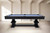 Plank & Hide Co Beaumont Slate Pool Table by Plank & Hide – Black Ash, sleek and modern pool table with a dark wooden finish, set in a minimalistic room with light-colored walls and flooring.