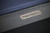 Plank & Hide Co Isaac Slate Pool Table in Black Ash, close-up of the branded metal plaque on the wooden surface.