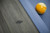 Plank & Hide Co Beaumont Slate Pool Table in Marble Grey, close-up of textured grey slate surface with blue cloth and a yellow billiard ball in the background.