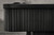 Doc & Holliday Slater Slate Pool Table - Matte Black Maple, close-up of the side with black wood paneling.