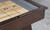 C.L. Bailey Tunbridge Shuffleboard in Weathered Brown, close-up of the wooden shuffleboard table with scoring system.