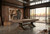 C.L. Bailey Viking Pool Table in Antique Oak, modern loft with large windows overlooking city skyline, rustic brick walls, and artistic decor.