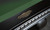 C.L. Bailey Dutchess Slate Pool Table, close-up view of the table's corner with a sleek black finish and a decorative gold emblem.